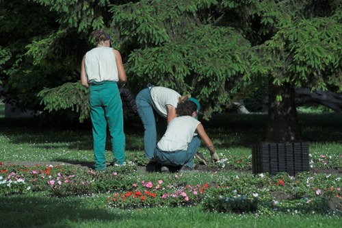 Team wearing PPE and preparing tools for hedge trimming